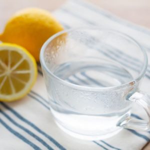 A glass of warm lemon water, symbolizing an easy and beneficial addition to a daily health routine
