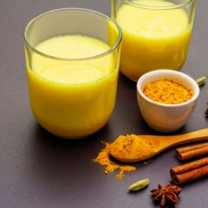 A vibrant yellow cup of turmeric milk, showcasing its numerous health benefits.